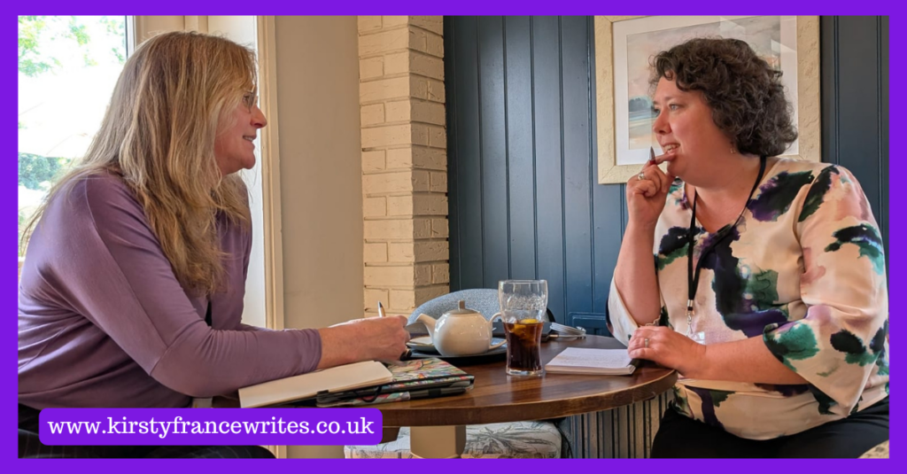 Image shows two women talking over notebooks and drinks. If you're wondering how a copywriter can sound like you, they usually do it by listening.