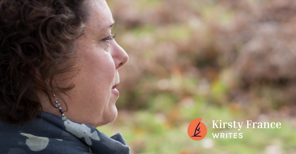 Image shows a woman with dark hair. She's thinking about ways to help you get ready to review your marketing.