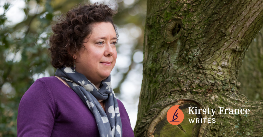 Image shows a dark haired woman leaning against a tree. She's thinking about how to create a marketing plan without the overwhelm.